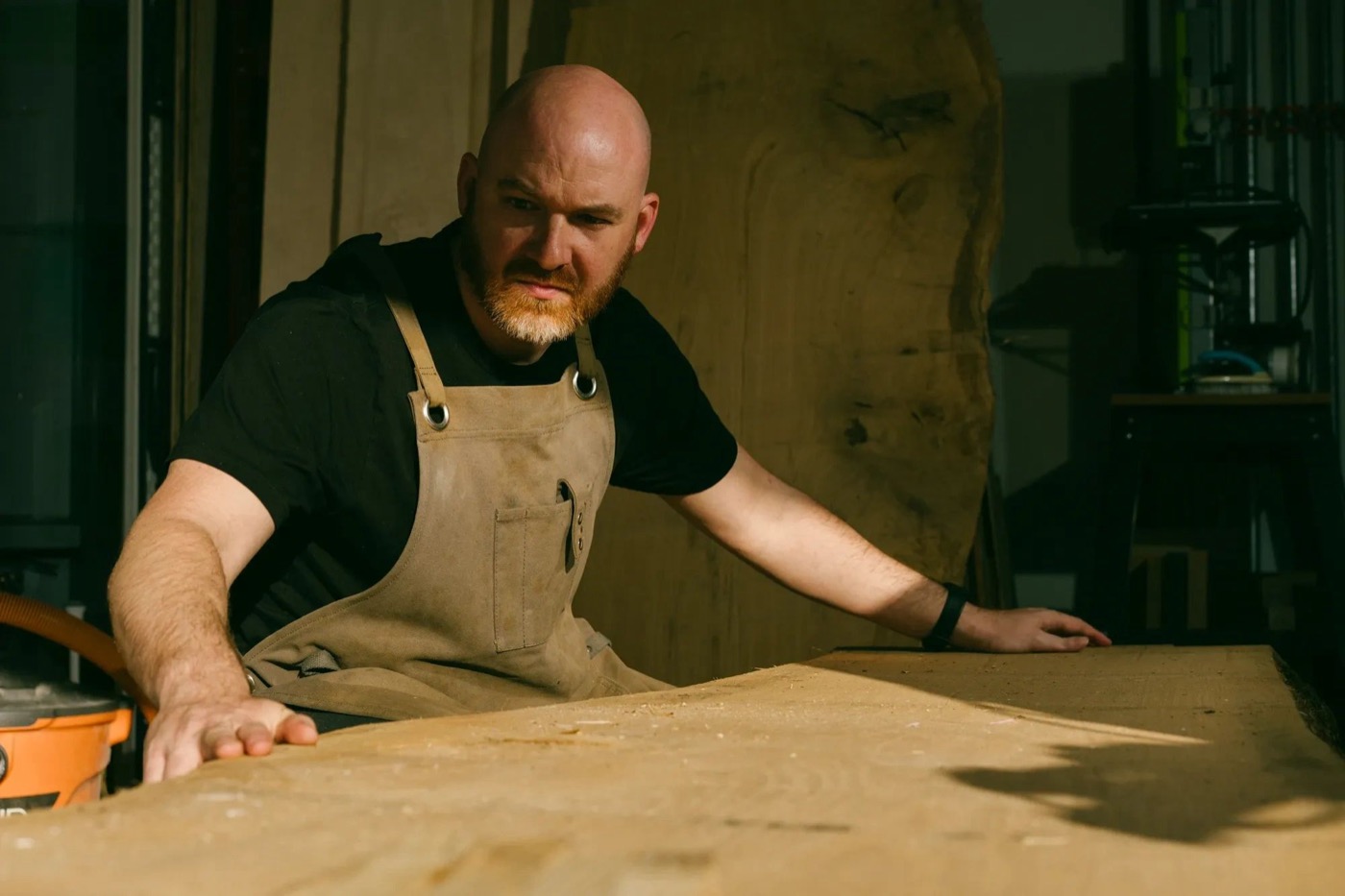 Kyle Svilar working with a live-edge slab in the shop