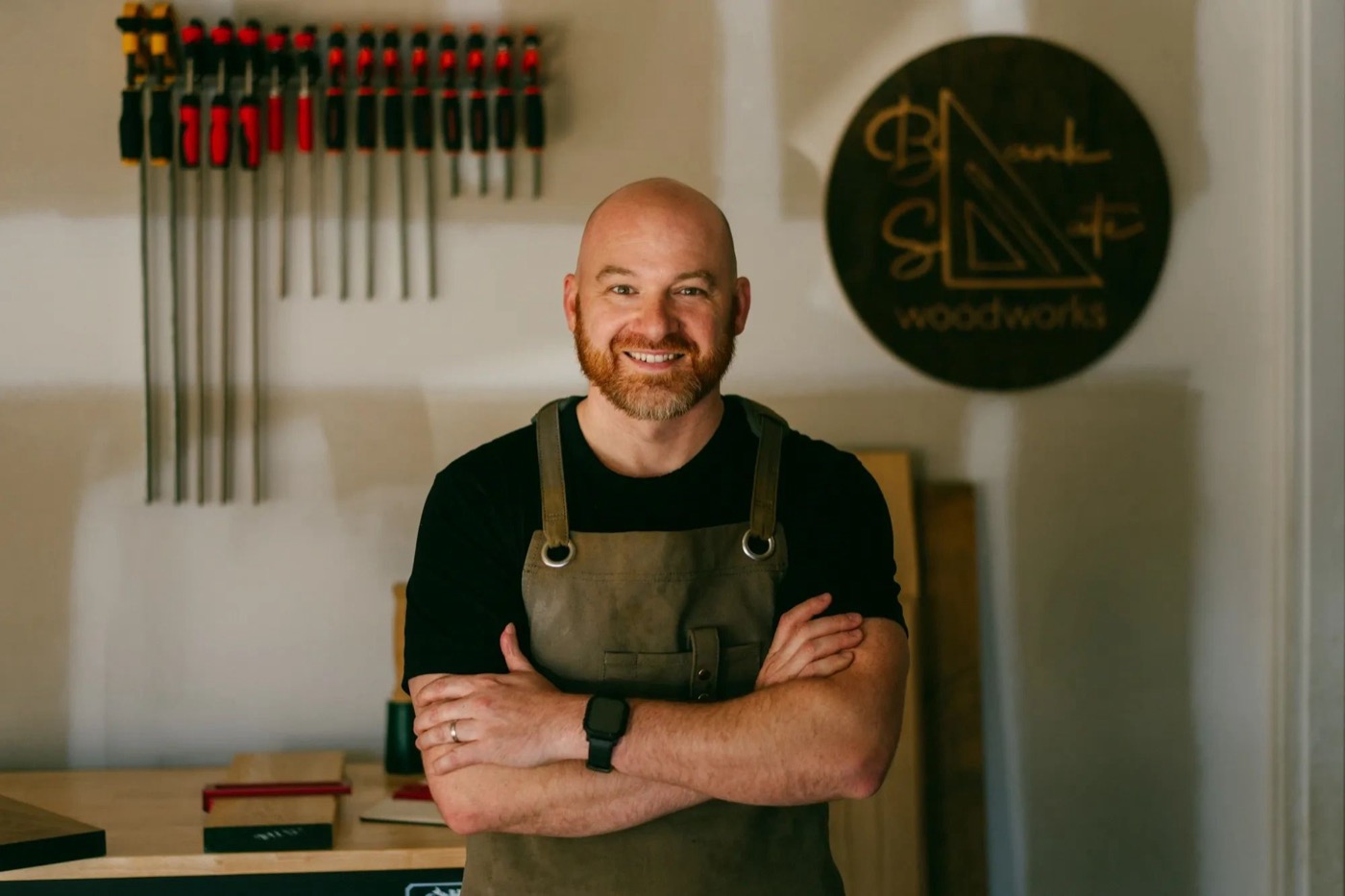 Kyle Svilar smiling in the Blank Slate Woodworks shop
