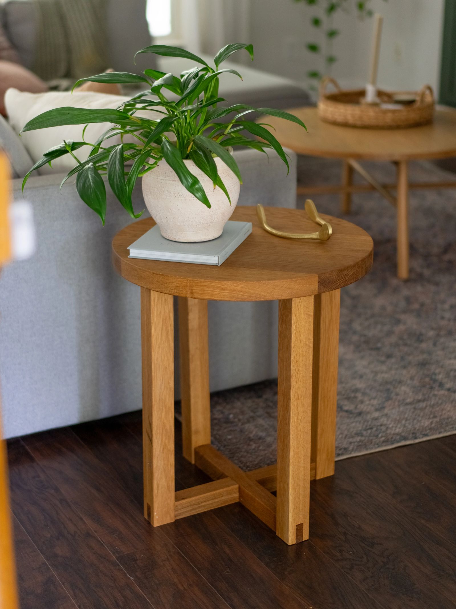 Handcrafted wood end table styled with a plant